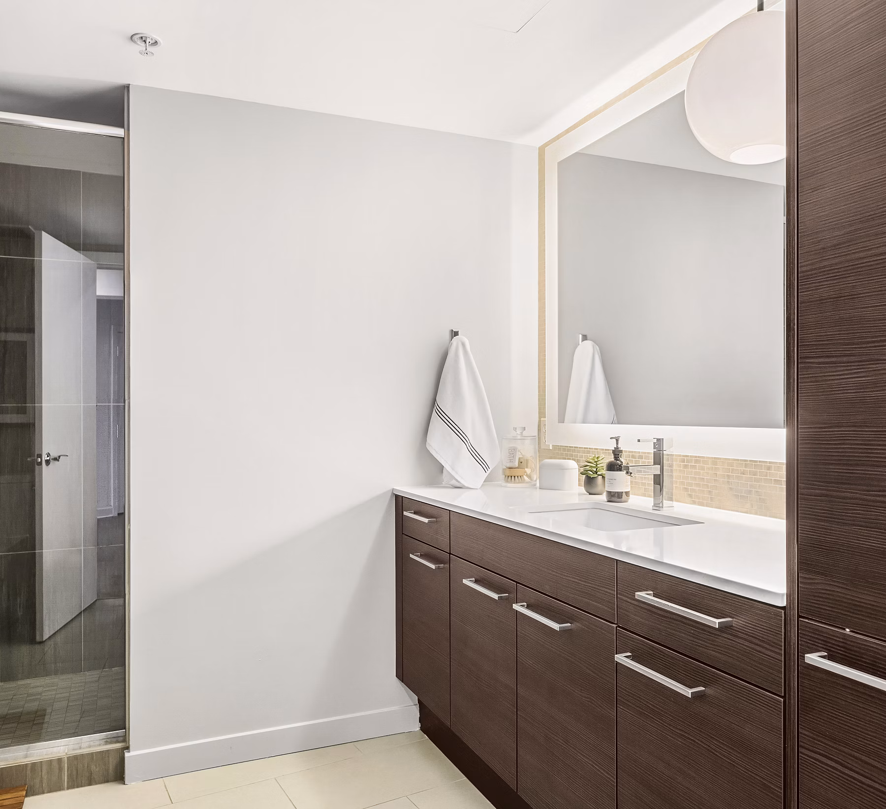 Bathroom featuring modern fixtures and elegant tiling at The Goodwin Apartments