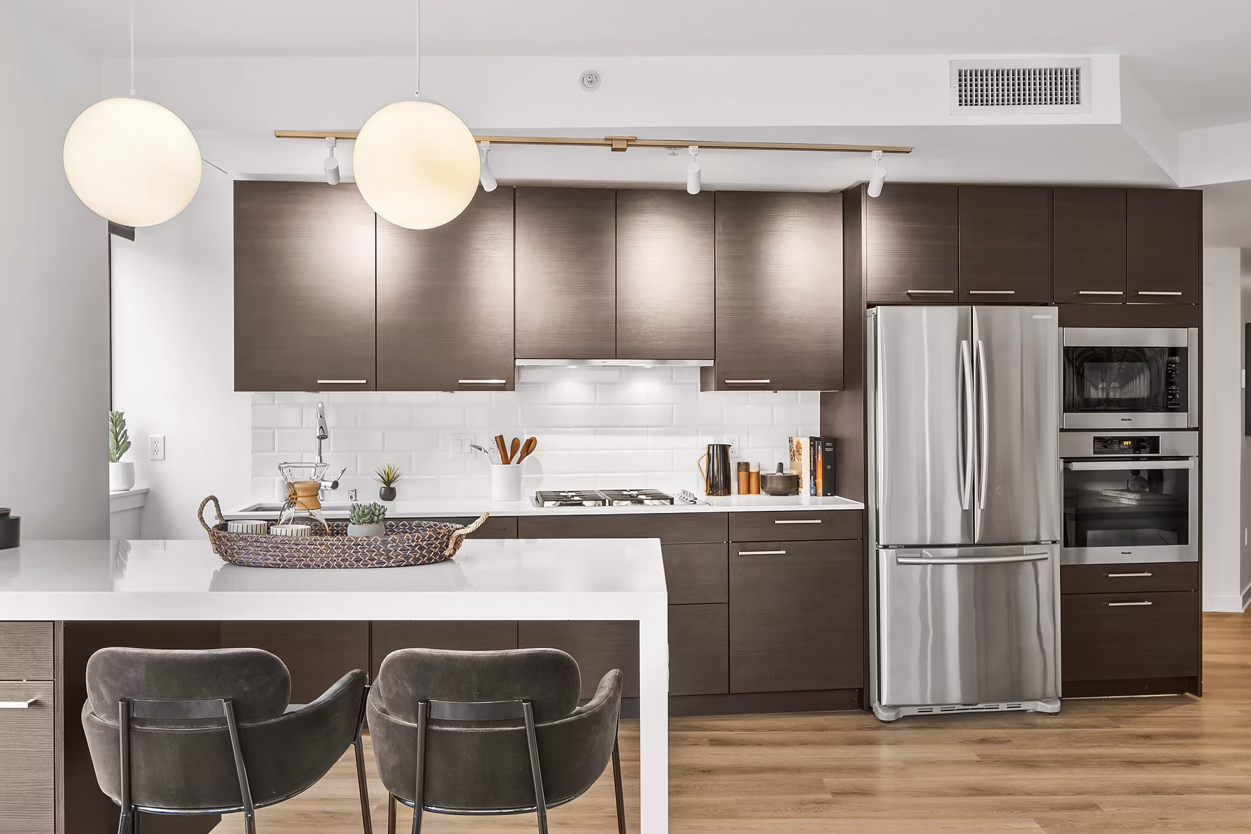 Kitchen featuring modern appliances and granite countertops in The Goodwin Apartments, a luxury residence designed by Bolis Properties