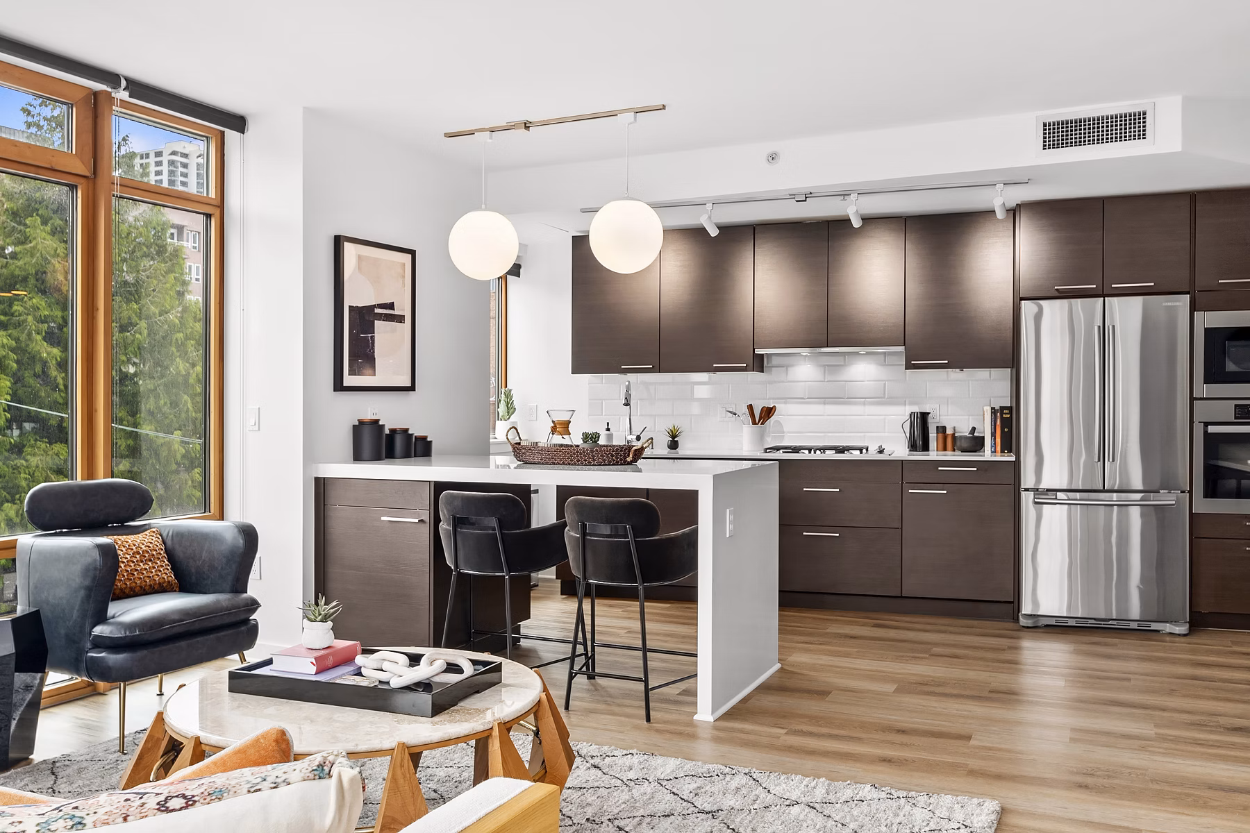 Modern kitchen with sleek countertops and stainless steel appliances at The Goodwin Apartments